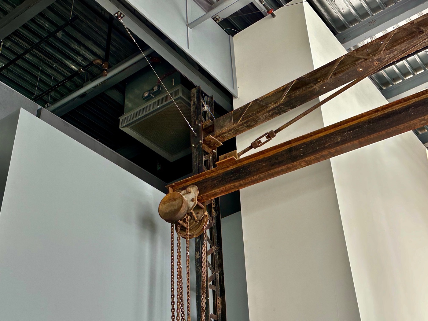 A rusted chain hoist and steel beams from the building's factory days inside the ICA Watershed.