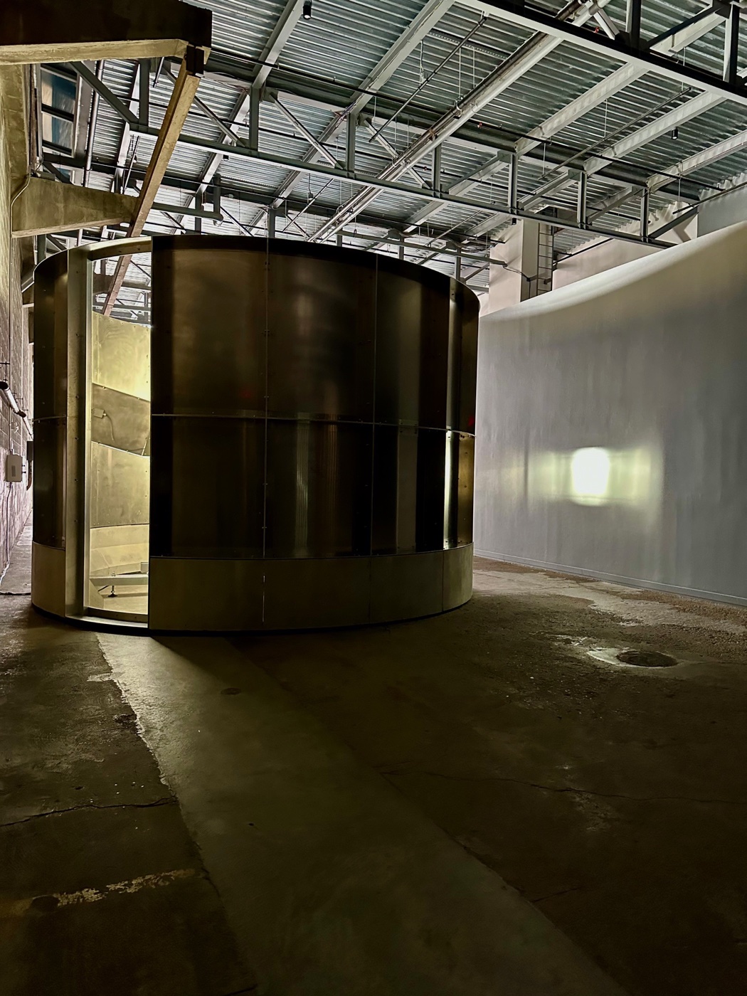 Lucy Raven's Hardpan, an aluminum and concrete cylinder glowing from within at the ICA Watershed.