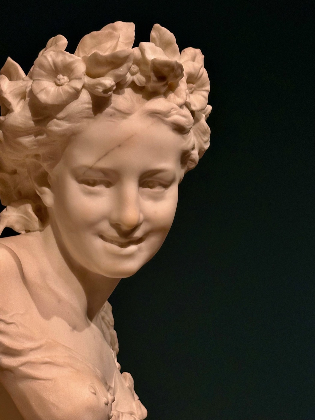 A marble bust of a woman crowned with carved flowers at Art in Bloom, Museum of Fine Arts, Boston.
