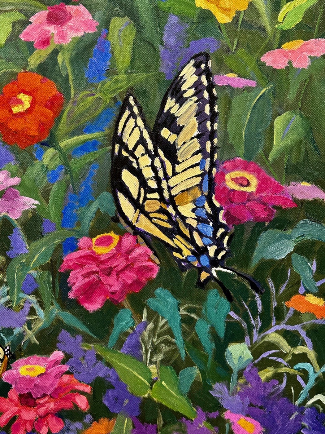 An oil painting of a butterfly among bright zinnias at the North Shore Arts Association, Gloucester.