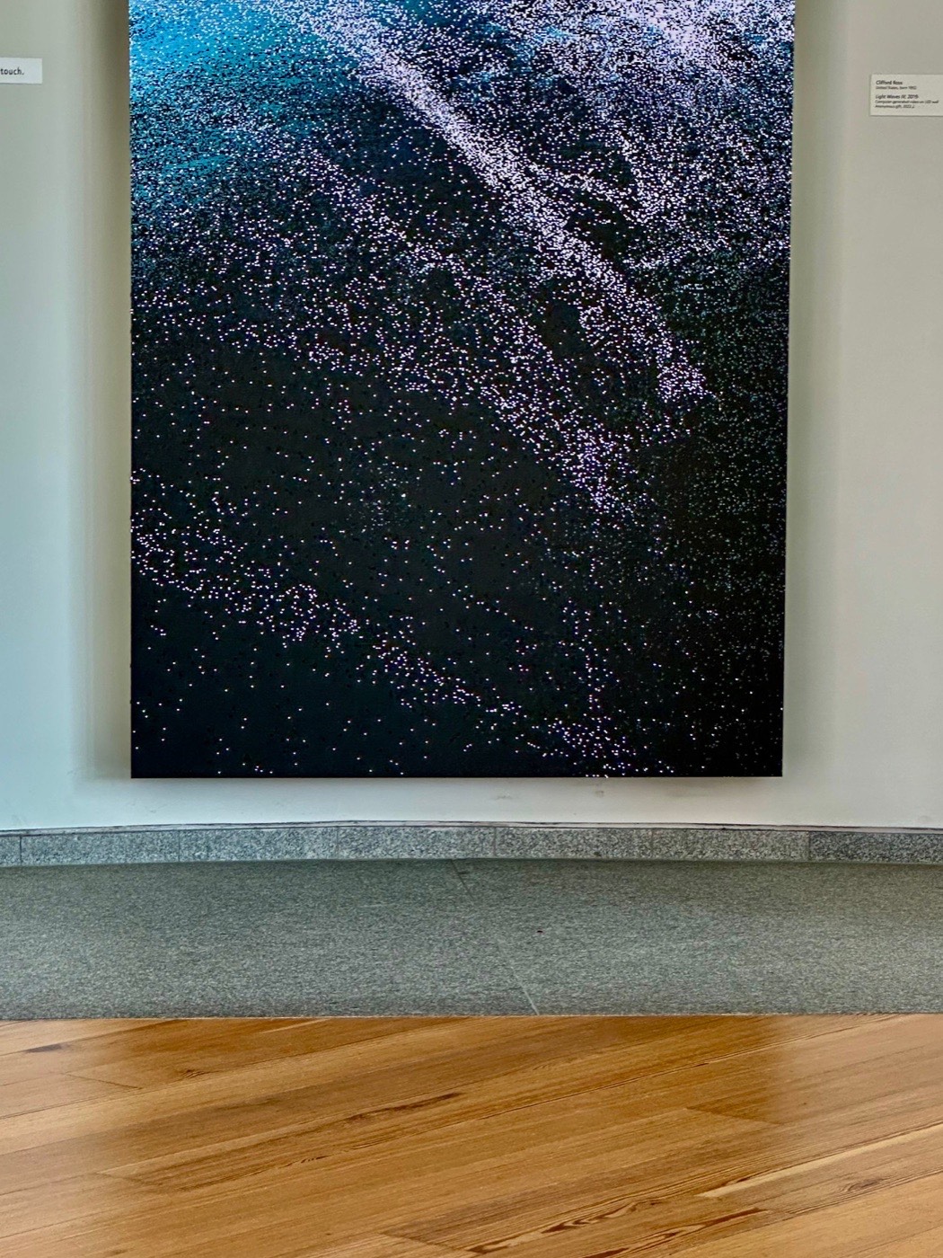 Light Waves by Clifford Ross, a computer-generated video on an LED wall, glittering like surf at the Portland Museum of Art.