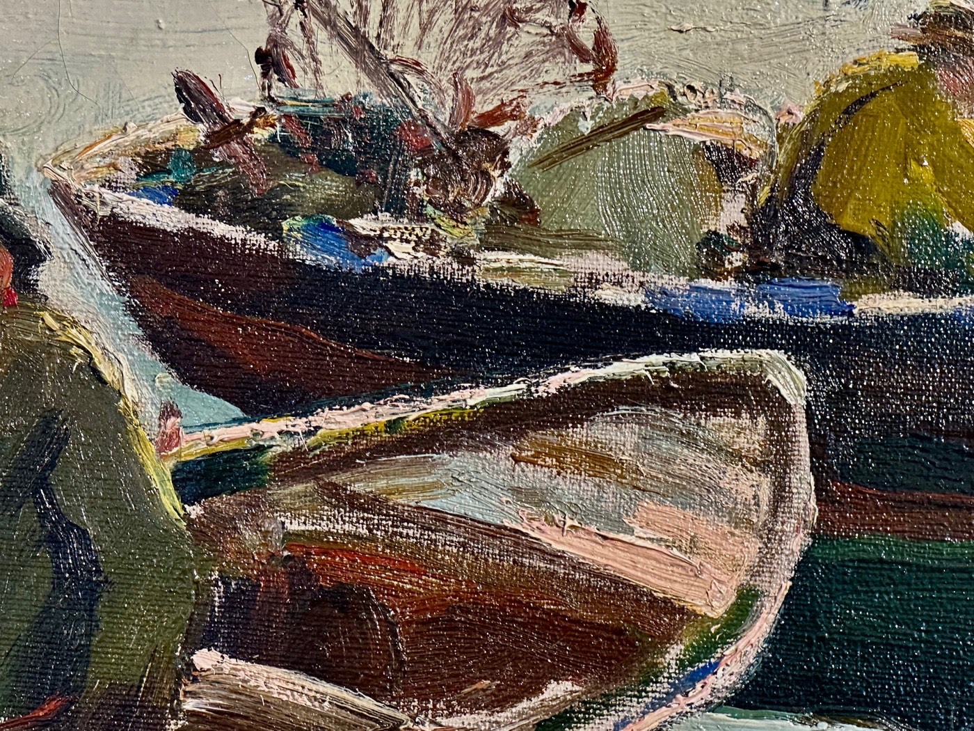 A close-up of an oil painting of fishing boats at the wharf at the Rockport Art Association.