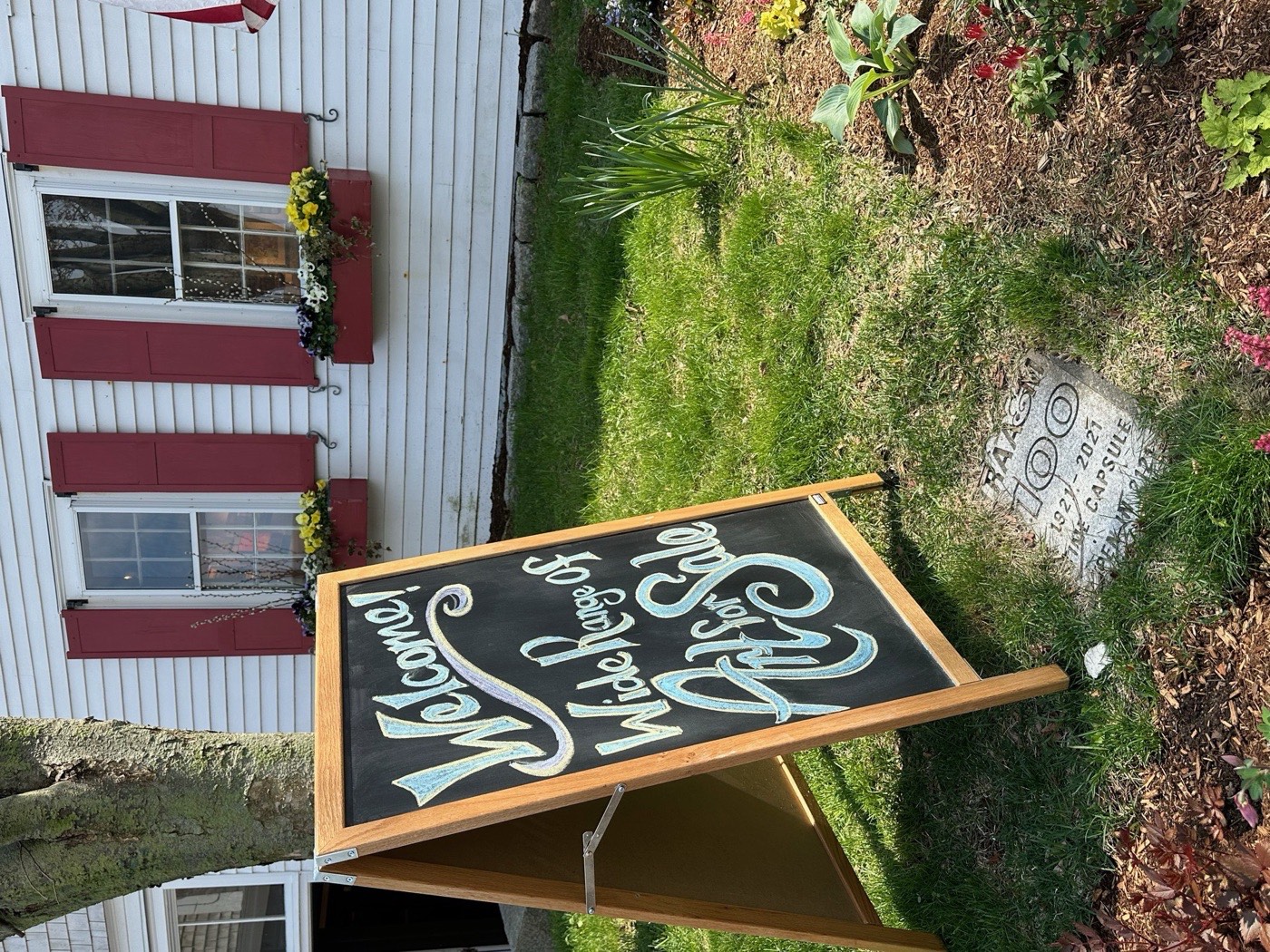A chalkboard sandwich sign reading Welcome, Wide Range of Art for Sale, at the Rockport Art Association.