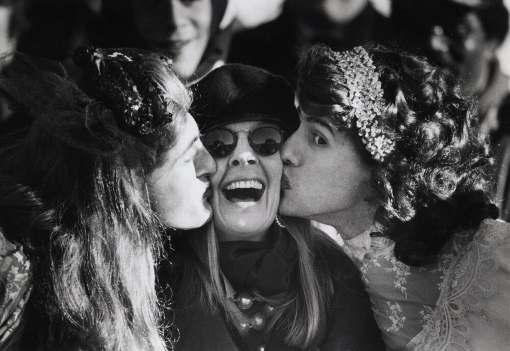 Diane Keaton laughing as Hasty Pudding members give her the traditional double kiss, 1991