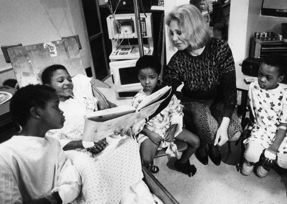 Joan Bennett Kennedy encouraging patients to read at Boston City Hospital, 1991