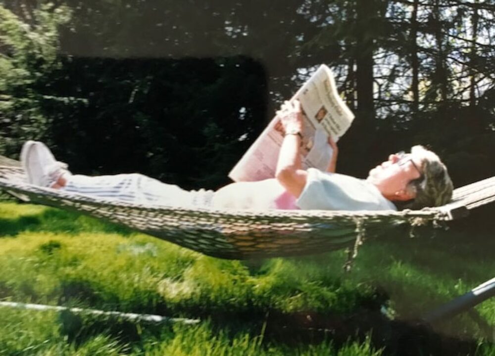 Loretta McLaughlin, the reporter who broke the Boston Strangler case, reading in her backyard