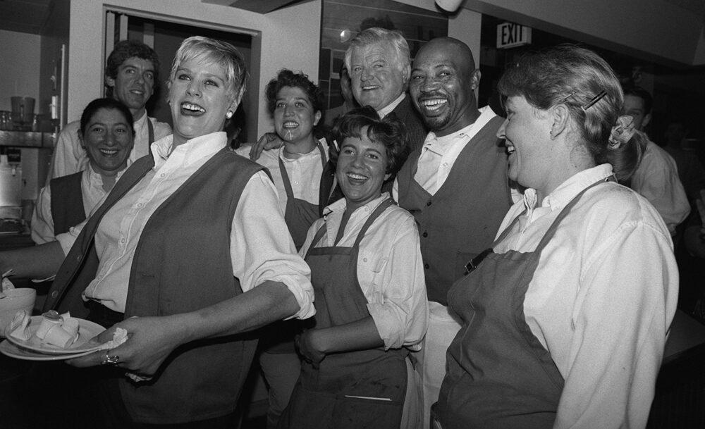 Waiters and waitresses at the S&S Deli posing with Senator Ted Kennedy during a Cambridge campaign stop